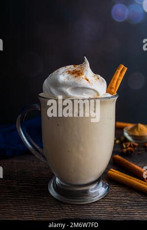 Chai Frappuccino in a Glass Mug Topped with Whipped Cream: Frappuccino made with chai tea and vanilla ice cream garnished with a cinnamon stick Stock Photo