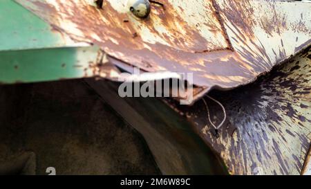 Hole or hole, armor deformation from a projectile close-up. Damaged armor of a Russian armored personnel carrier by shell fragme Stock Photo