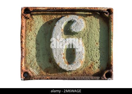 Old retro weathered cast iron plate with number 6 closeup isolated on white background Stock Photo