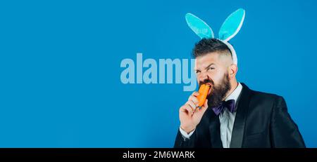 Happy easter egg. Smile easter man. Man in suit with bunny rabbit ears. Easter bunny dress. Horizontal photo banner for website header design. Stock Photo