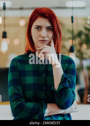 Headshot portrait of a modern woman in the office at night by the window Stock Photo