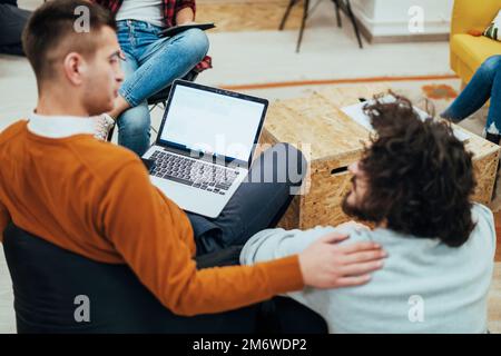 Two men having fun on a break from work in a modern office Stock Photo