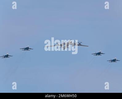MOSCOW, RUSSIA - MAY 7, 2022: Avia parade in Moscow. su-35 and strategic bomber and missile platform Tu-95 in the sky on parade Stock Photo