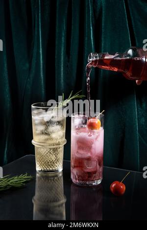 Two vibrant and sparkling alcoholic punch is perfect for Christmas party. Colorful cocktails in glasses.  Fresh holiday drinks. Stock Photo