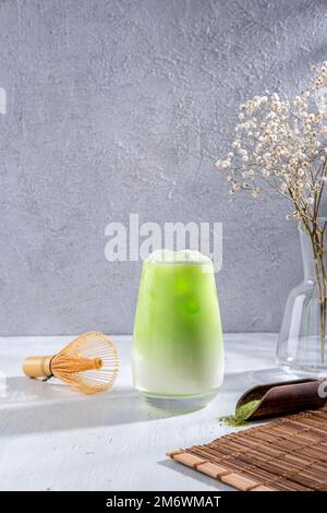 Matcha tea. Iced green tea matcha latte  in glass. Green tea dalgona, whipped grean tea with milk. Healthy vegan drink, close up Stock Photo