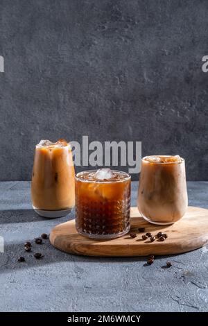 Espresso Tonic, cold drink with espresso and tonic in glass. Ice coffee in a tall glass with cream poured over and coffee beans. Stock Photo