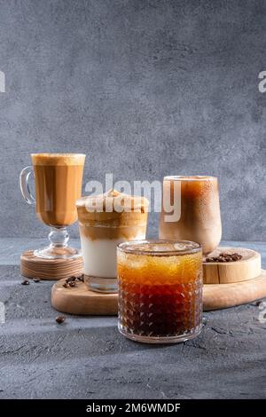 Espresso Tonic, cold drink with espresso and tonic in glass. Ice coffee in a tall glass with cream poured over and coffee beans. Stock Photo