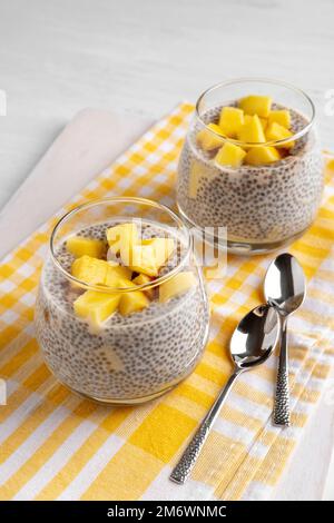 Vegan chia coconut pudding with mango on white background. Healthy nutrition, superfood. Closeup view. Stock Photo