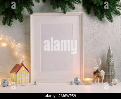 Christmas composition of Christmas decorations, pine branches, House lantern and a white mock up poster frame for presentation o Stock Photo