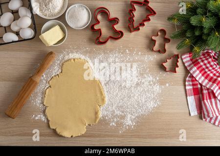 Rolled out dough for making gingerbread cookies. Making Christmas Cookies with traditional gingerbread cookies ingredients. Chri Stock Photo