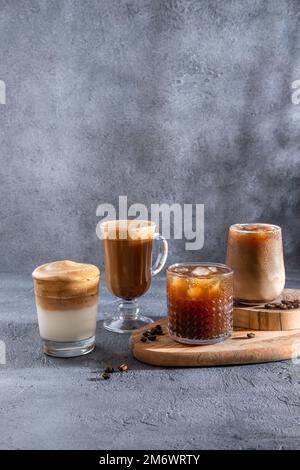 Espresso Tonic, cold drink with espresso and tonic in glass. Ice coffee in a tall glass with cream poured over and coffee beans. Stock Photo