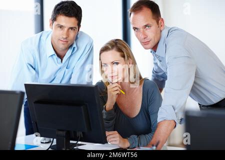 Showing them whos boss. a group of workers looking serious in their office. Stock Photo