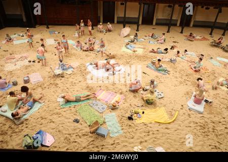 Sydney, Australia. 6th January 2023. Making its Australian premiere on Friday 6 January, the award-winning Sun & Sea will be staged in Sydney Town Hall and transformed to become a beachscape, complete with sand, sunbathers and holidaymakers. A sellout at the 2019 Venice Biennale where it was awarded the Golden Lion, Sun & Sea is a durational English-language opera work in-the-round that confronts themes of climate emergency with humour and power. Credit: Richard Milnes/Alamy Live News Stock Photo