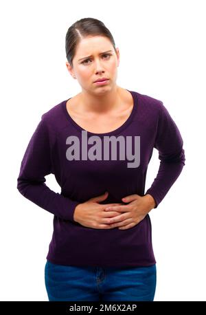 Maybe I shouldnt have had that second helping. Studio shot of a young woman in pain isolated on white. Stock Photo