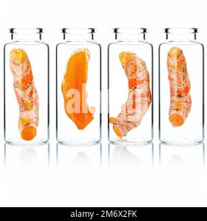 Homemade skin care turmeric root in glass bottles isolated on white background. Stock Photo