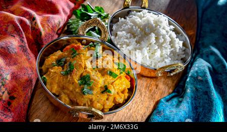 Curry chicken with rice served in original indian karahi pots. Stock Photo
