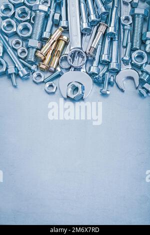Anchor bolts screwbolts nuts hook wrenches and flat spanners construction concept. Stock Photo