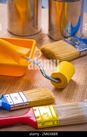 big set of painting tools on wooden board paint brushes roller tray cans Stock Photo