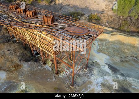 Drone aerial of abandoned copper mine and demolished steel machinery. Environmental pollution land contamination Stock Photo