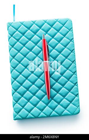 blue soft leather note pad and red ballpoint pen isolated on white background Stock Photo
