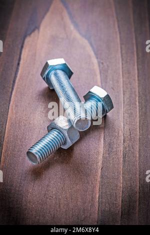 bolts and nut on vintage wooden board construction concept Stock Photo