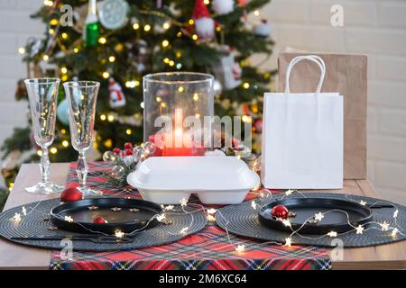 Food delivery service containers on table, festively served for the celebration of Christmas and new year. Tableware and loft-st Stock Photo