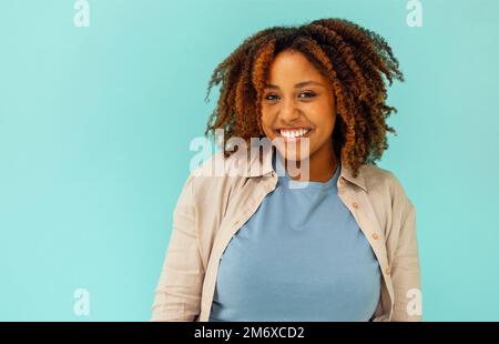 Cheerful good looking carefree young african american woman showing calm down Stock Photo