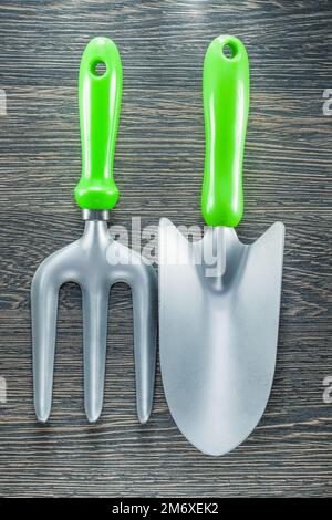 Gardening trowel fork hand spade on wooden board. Stock Photo
