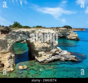 Picturesque seascape with cliffs, rocky arch and stacks (faraglioni), at Torre Sant Andrea, Salento sea coast, Puglia, Italy Stock Photo