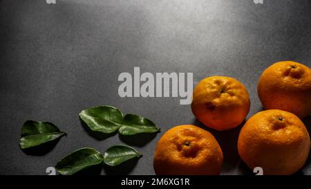 Indonesian orange fruits isolated on black background and natural light Stock Photo