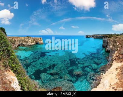 Picturesque seascape with cliffs, rocky arch and stacks (faraglioni), at Torre Sant Andrea, Salento sea coast, Puglia, Italy. Stock Photo