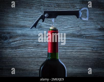 corckscrew on bottle of red wine Stock Photo
