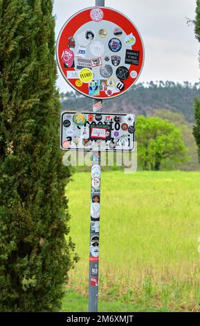 Road sign full with stickers in the countryside Stock Photo