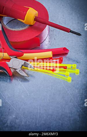 Insulating tape electric wires plastic cable ties screwdriver cutting pliers. Stock Photo