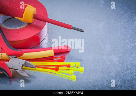 Insulating tape electric wires plastic cable ties screwdriver nippers. Stock Photo