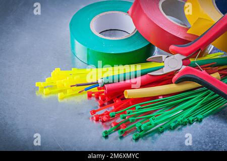 Insulating tapes plastic cable ties electric wires cutting pliers. Stock Photo