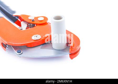 isolated pipe cutter with plastical pipe close up Stock Photo