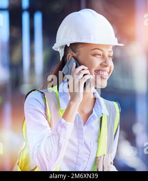 Construction worker, woman with smartphone for phone call and communication with technology and helmet for safety. Happy with construction, building Stock Photo