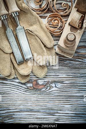 Leather protective gloves lump hammer chisels planer planning chips. Stock Photo