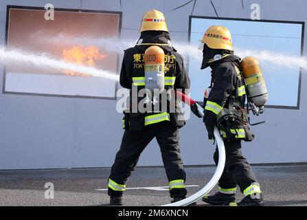 Tokyo, Japan. 6th Jan, 2023. Fire fighters demonstrate to spray water for firefighting at an annual fire brigade review in Tokyo on Friday, January 6, 2023. Some 2,500 personnel and 99 vehicles participated the New Year event. Credit: Yoshio Tsunoda/AFLO/Alamy Live News Stock Photo