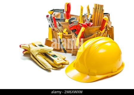 helmet gloves and construction tools in tool belt isolated on white Stock Photo
