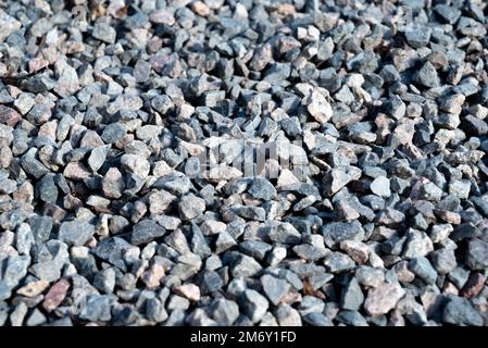Granite gravel texture.close up gravel texture.Gray gravel background, gray texture next to house, close up view from top. Stock Photo