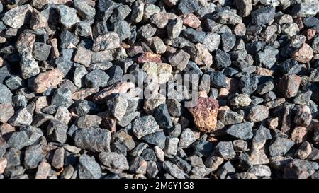 Granite gravel texture.close up gravel texture.Gray gravel background, gray texture next to house, close up view from top. Stock Photo