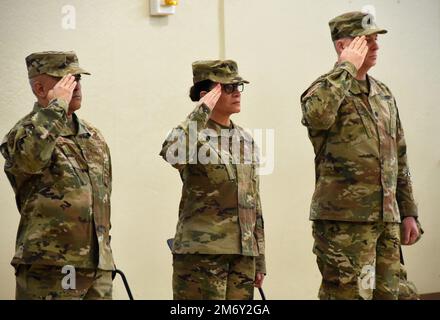 New York Air National Guard Col Paul A Salas (left), the outgoing Commander of Joint Task Force Empire Shield, Brig. Gen. Isabel Smith, Director Joint Staff, New York National, and New York Army National Guard Lt. Col. Jeffrey Roth, the incoming commander salute during the playing of the National Anthem during the task force  change of command ceremony held at the Fort Hamilton Army Garrison Reserve Center, Brooklyn, NY, on May 9, 2022. The Army and Air National Guardsmen, along with members of the New York Guard and New York Naval Militia assigned to the task force , and serving in  State Act Stock Photo