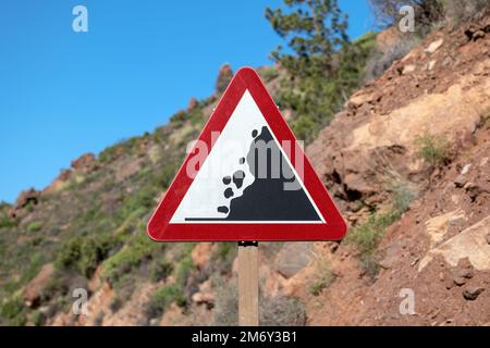 Warning sign 'Rockfall' in mountain region. Stock Photo