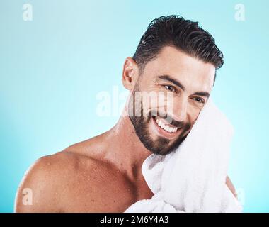 Shower, towel and man cleaning face during morning dermatology treatment, luxury bathroom routine or beauty self care. Spa salon, wellness and model Stock Photo