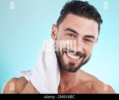 Shower towel, portrait and man cleaning face for morning dermatology treatment, luxury bathroom routine or beauty self care. Spa salon, wellness and Stock Photo