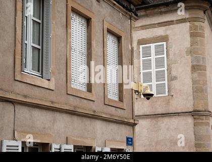 Surveillance camera in the street. Surveillance camera hanging on the wall. Security concept. Face recognition. Search programs for criminals. Stock Photo