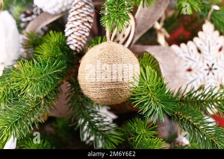 Natural Christmas tree ornament bauble made from beige and white jute rope Stock Photo