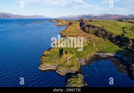 Drone aerial view of Castle Coeffin, Isle of Lismore, Argyll, Scotland. Looking north east up Loch Linnhe towards Lochaber with Ben Nevis visible Stock Photo